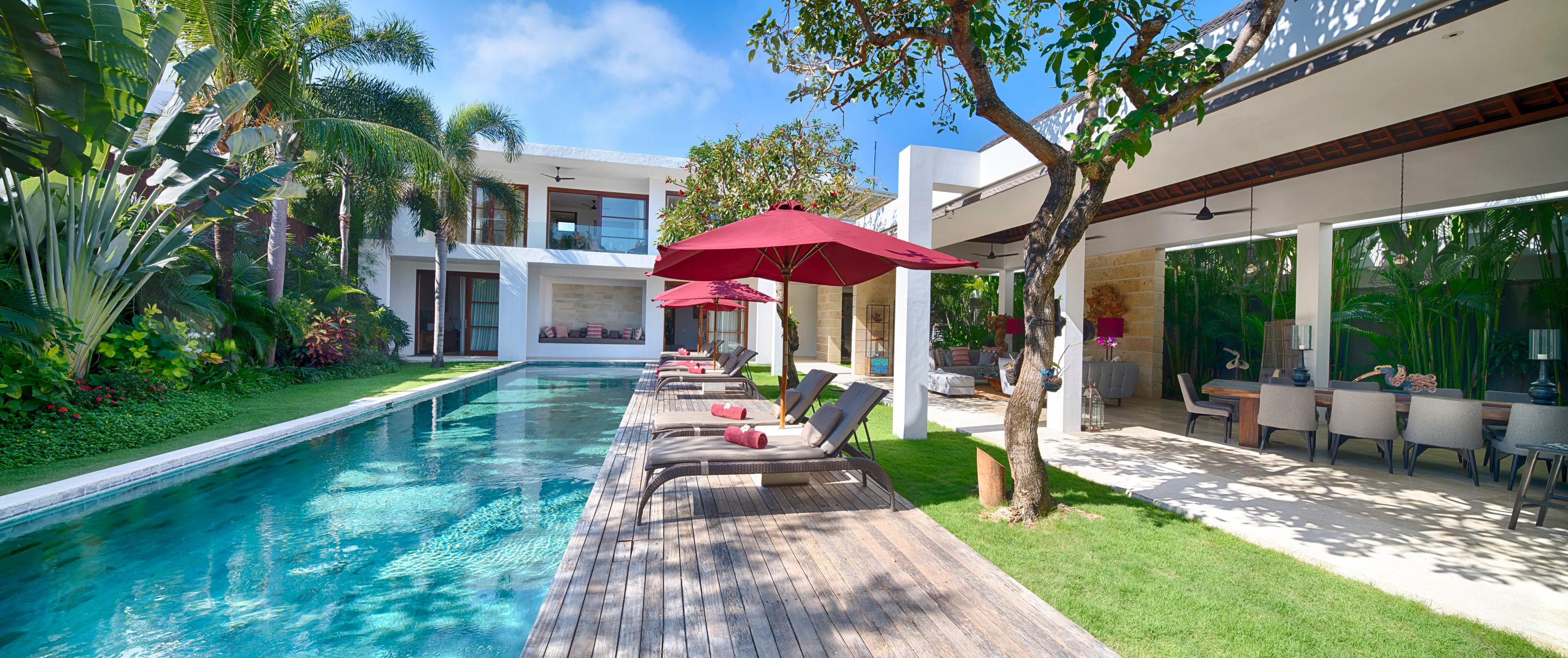 The pool and lawn at Casa Brio, looking down the length of the water to the two-level bedroom pavilion